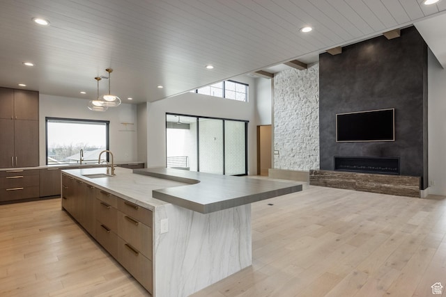 13926 S Jarvie Ln E, Draper, UT 84020 - kitchen featuring open floor plan, a healthy amount of sunlight, a sink, light wood finished floors, and modern cabinets