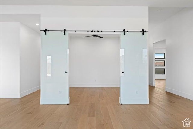 121 E Terrace Ln, Ivins, UT 84738 - unfurnished room with a barn door, light wood finished floors, and baseboards