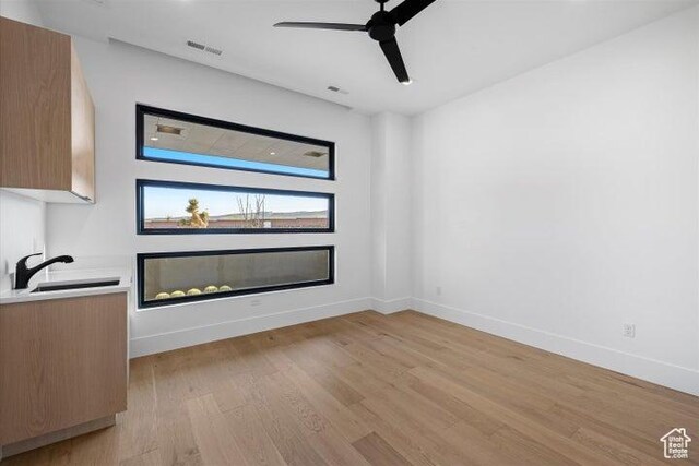 121 E Terrace Ln, Ivins, UT 84738 - unfurnished living room with baseboards, a ceiling fan, light wood-style floors, and visible vents