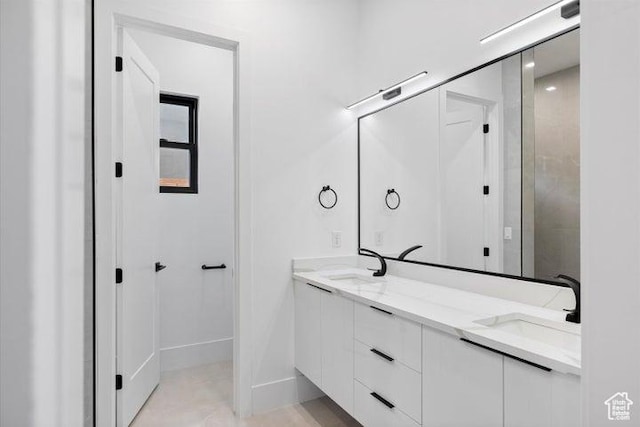 121 E Terrace Ln, Ivins, UT 84738 - bathroom featuring double vanity, baseboards, and a sink