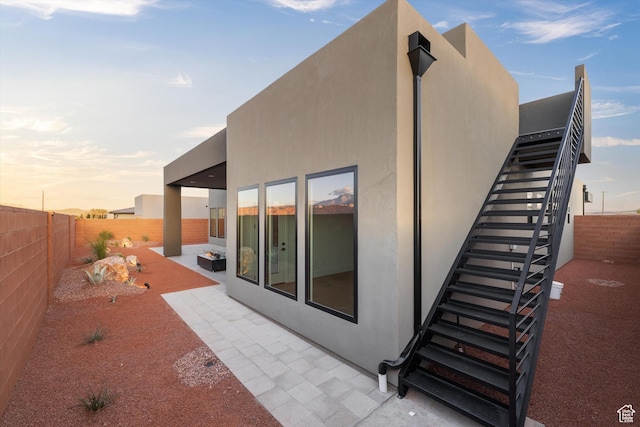 121 E Terrace Ln, Ivins, UT 84738 - rear view of house with a patio, a fenced backyard, stairs, and stucco siding