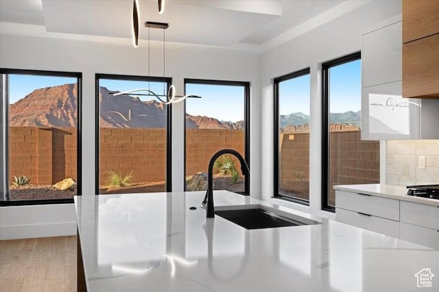 121 E Terrace Ln, Ivins, UT 84738 - details featuring light wood finished floors, a sink, a mountain view, modern cabinets, and light countertops