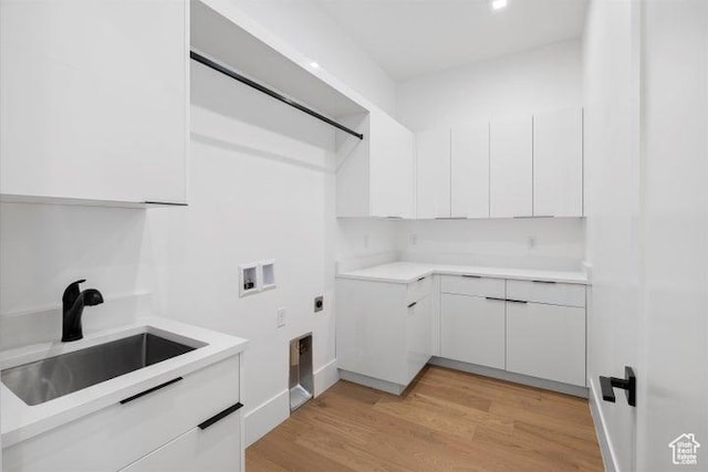 121 E Terrace Ln, Ivins, UT 84738 - washroom featuring a sink, hookup for an electric dryer, cabinet space, light wood finished floors, and washer hookup