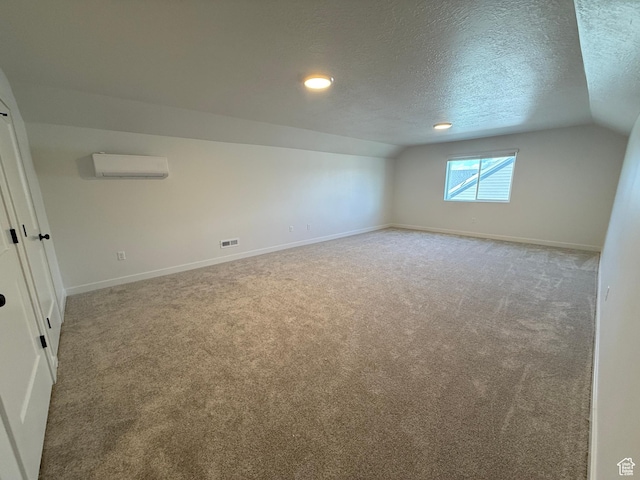 6 S 3830 W Unit 417, West Point, UT 84015 - interior space with baseboards, vaulted ceiling, carpet flooring, and a wall mounted AC