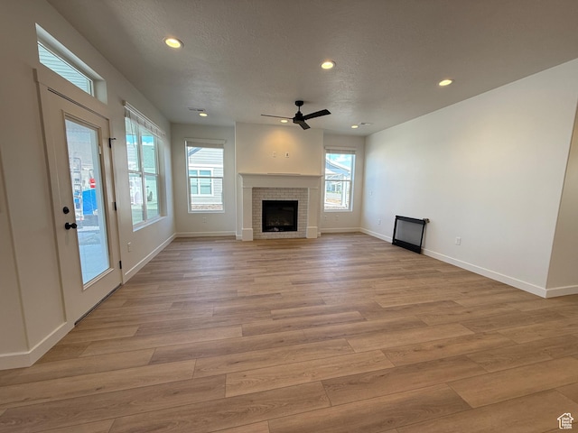 6 S 3830 W Unit 417, West Point, UT 84015 - unfurnished living room featuring ceiling fan, light wood finished floors, a fireplace, baseboards, and recessed lighting