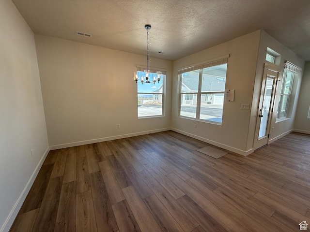 6 S 3830 W Unit 417, West Point, UT 84015 - unfurnished dining area featuring baseboards, visible vents, dark wood-style floors, and an inviting chandelier
