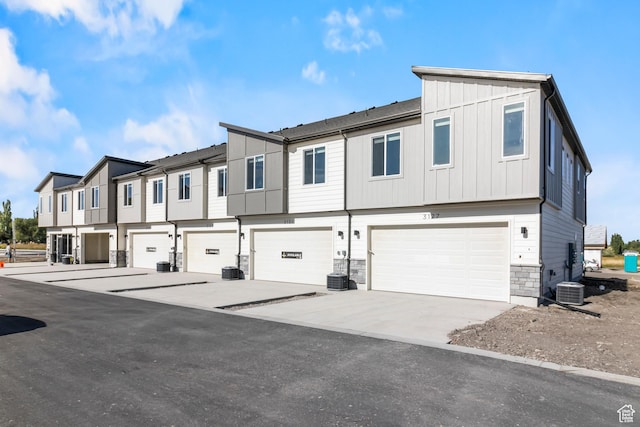 3175 S 208 W, Nibley, UT 84321 - view of property with stone siding, an attached garage, board and batten siding, a residential view, and driveway