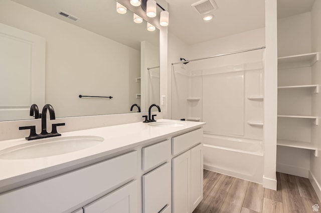 bathroom featuring a sink, visible vents, and wood finished floors