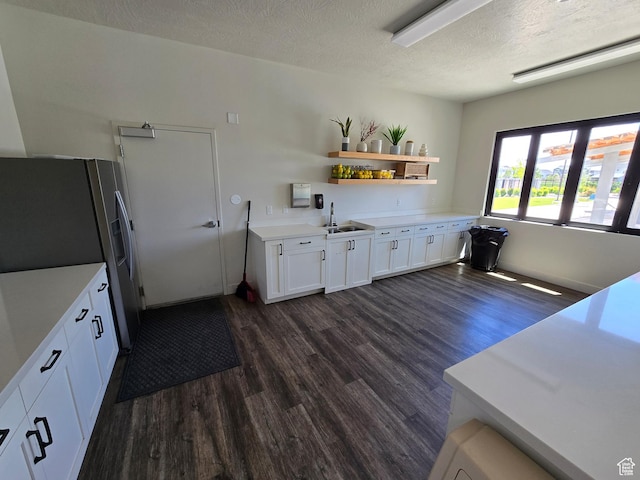15 W Seasons Dr, Vineyard, UT 84059 - kitchen featuring dark wood-style flooring, a sink, stainless steel fridge, white cabinets, and light countertops
