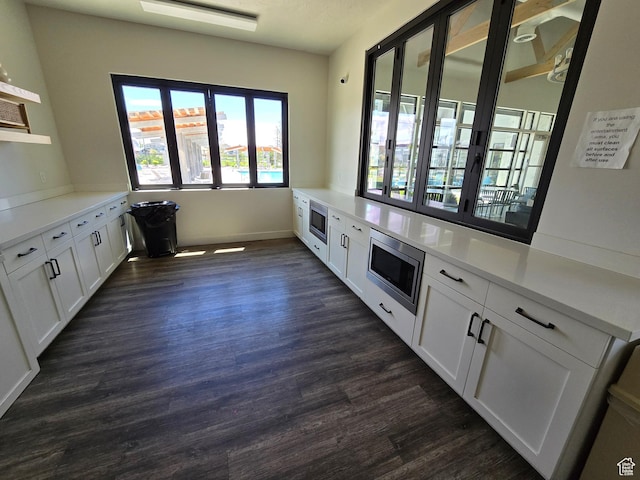 15 W Seasons Dr, Vineyard, UT 84059 - unfurnished dining area featuring dark wood-style floors and baseboards