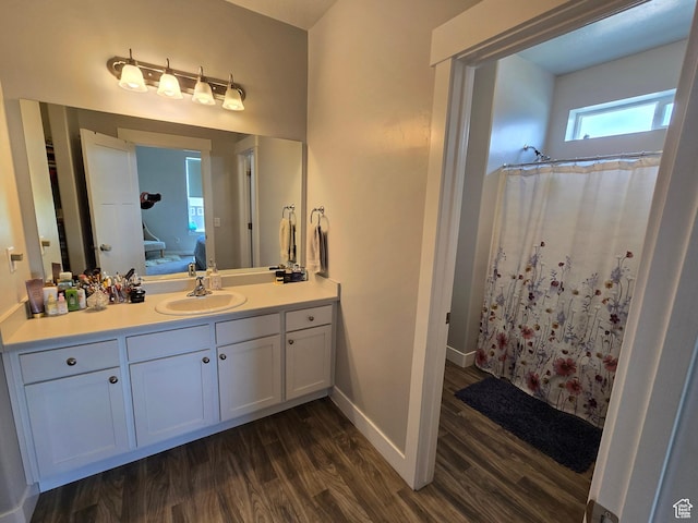15 W Seasons Dr, Vineyard, UT 84059 - full bathroom featuring wood finished floors, vanity, baseboards, connected bathroom, and curtained shower