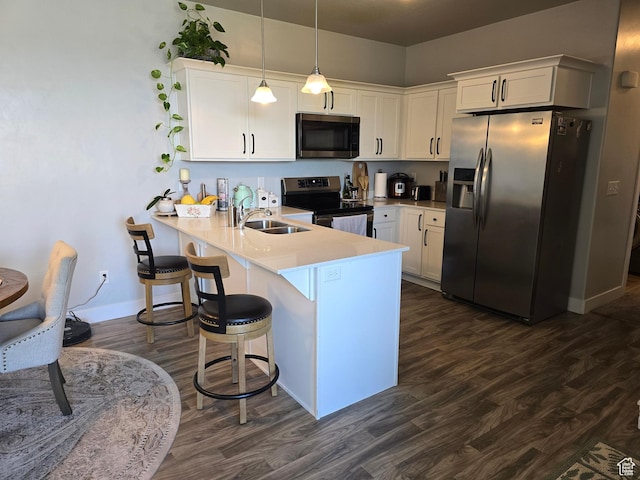15 W Seasons Dr, Vineyard, UT 84059 - kitchen featuring appliances with stainless steel finishes, a peninsula, a sink, and white cabinets