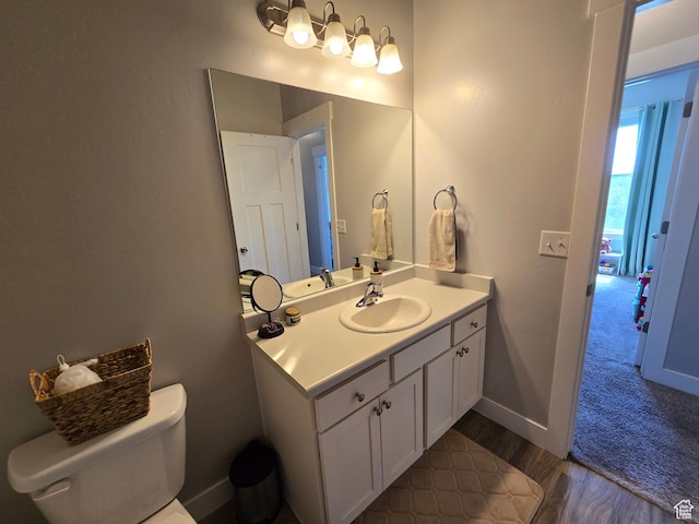 15 W Seasons Dr, Vineyard, UT 84059 - bathroom featuring vanity, toilet, wood finished floors, and baseboards