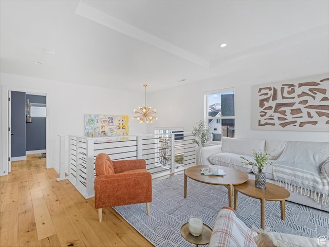 12224 N Bridgegate Way, Highland, UT 84003 - living area featuring light wood-style flooring, a notable chandelier, a raised ceiling, and recessed lighting