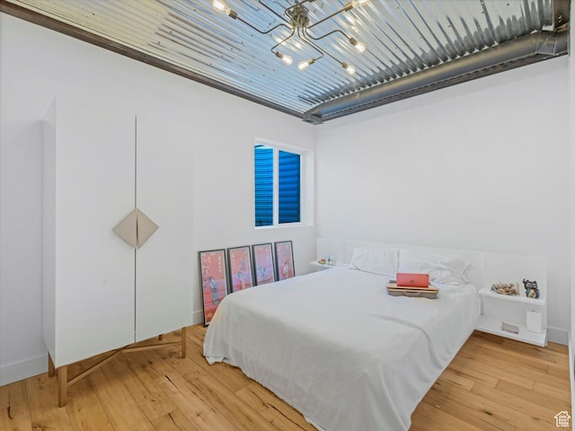 12224 N Bridgegate Way, Highland, UT 84003 - bedroom with a notable chandelier and light wood finished floors