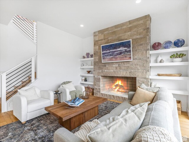 12224 N Bridgegate Way, Highland, UT 84003 - living area featuring stairs, wood finished floors, recessed lighting, and a stone fireplace