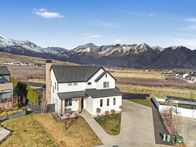 12224 N Bridgegate Way, Highland, UT 84003 - modern farmhouse style home with driveway, roof with shingles, fence, board and batten siding, and a mountain view
