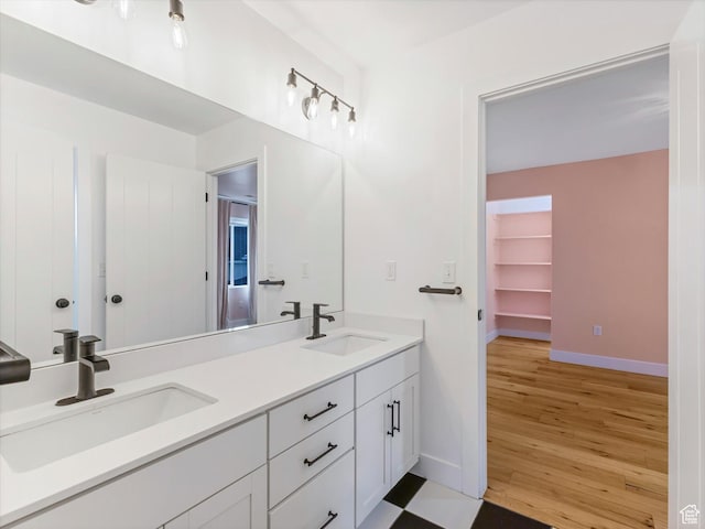 12224 N Bridgegate Way, Highland, UT 84003 - bathroom with double vanity, wood finished floors, baseboards, and a sink