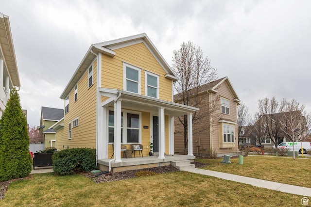 traditional-style house featuring covered porch and a front lawn