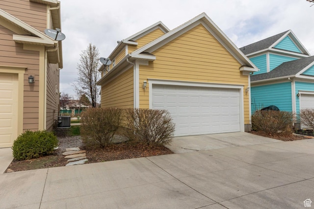 exterior space featuring central AC unit and a garage