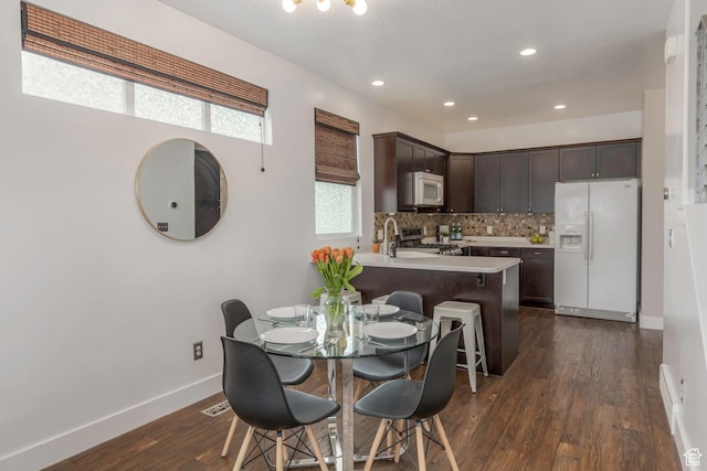 dining room with recessed lighting, baseboards, visible vents, and dark wood finished floors