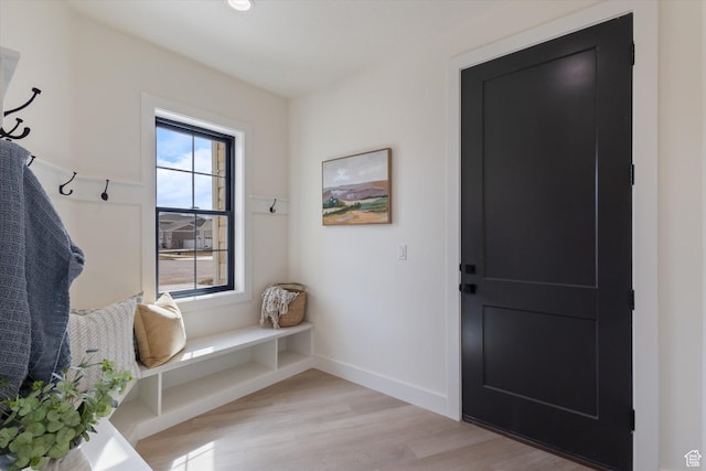 mudroom with baseboards and light wood-type flooring