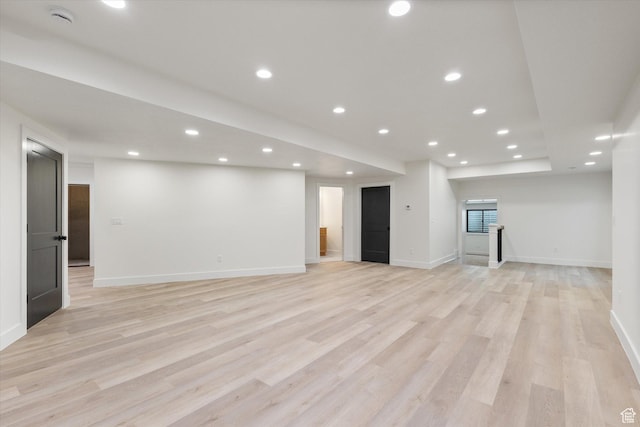interior space featuring light wood-type flooring, baseboards, and recessed lighting