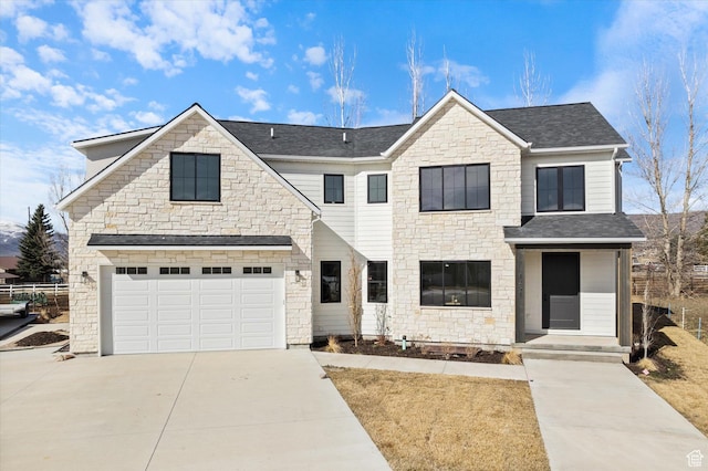 view of front of house featuring a shingled roof, an attached garage, stone siding, and concrete driveway