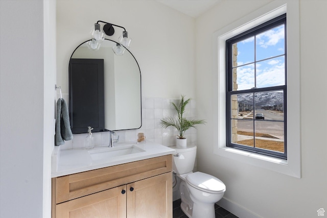 half bath with toilet, vanity, and tile walls