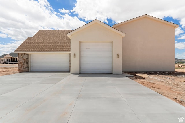 4416 W 1900 S, Cedar City, UT 84720 - view of front of property with an attached garage, stucco siding, concrete driveway, stone siding, and roof with shingles