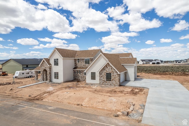 4416 W 1900 S, Cedar City, UT 84720 - view of front of house with stone siding, stucco siding, driveway, and a garage