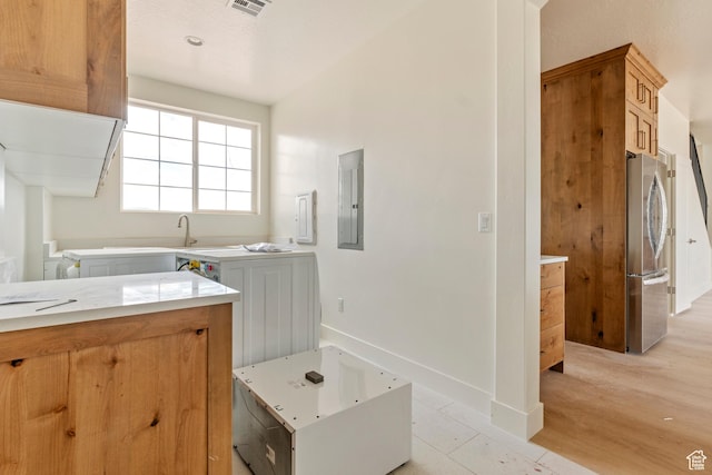 4416 W 1900 S, Cedar City, UT 84720 - kitchen featuring freestanding refrigerator, electric panel, light countertops, baseboards, and light wood-style flooring
