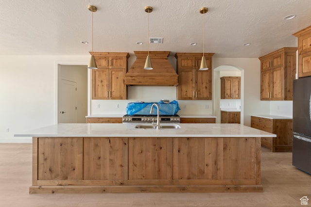 4416 W 1900 S, Cedar City, UT 84720 - kitchen featuring custom exhaust hood, freestanding refrigerator, light wood-type flooring, arched walkways, and recessed lighting