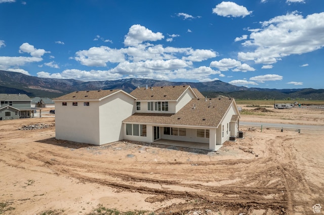 4416 W 1900 S, Cedar City, UT 84720 - back of house featuring a mountain view, a patio area, stucco siding, and central air condition unit