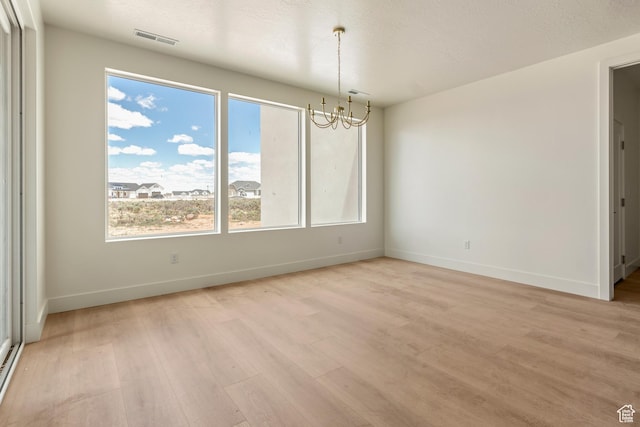 4416 W 1900 S, Cedar City, UT 84720 - empty room featuring a chandelier, light wood-style floors, and baseboards