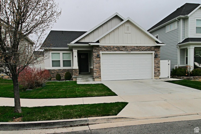 craftsman-style house featuring stone siding, an attached garage, a front lawn, board and batten siding, and driveway