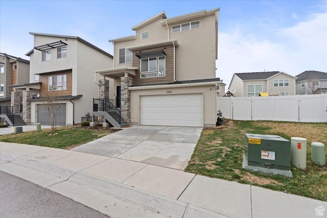 13192 S Lowick Ln, Herriman, UT 84096 - view of front of home with fence, driveway, stucco siding, and a garage