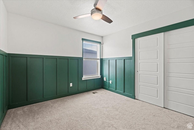 13192 S Lowick Ln, Herriman, UT 84096 - carpeted empty room with wainscoting, a textured ceiling, and ceiling fan