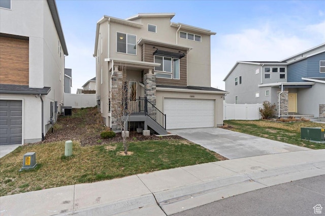 13192 S Lowick Ln, Herriman, UT 84096 - view of front of house with driveway, stucco siding, fence, an attached garage, and central AC unit