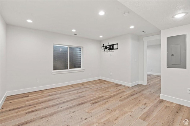 13192 S Lowick Ln, Herriman, UT 84096 - empty room with light wood-style floors, recessed lighting, baseboards, and electric panel
