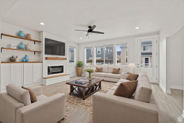 13192 S Lowick Ln, Herriman, UT 84096 - living area with recessed lighting, baseboards, a large fireplace, light wood finished floors, and ceiling fan