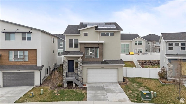 13192 S Lowick Ln, Herriman, UT 84096 - view of front facade featuring roof mounted solar panels, a garage, stucco siding, a residential view, and driveway