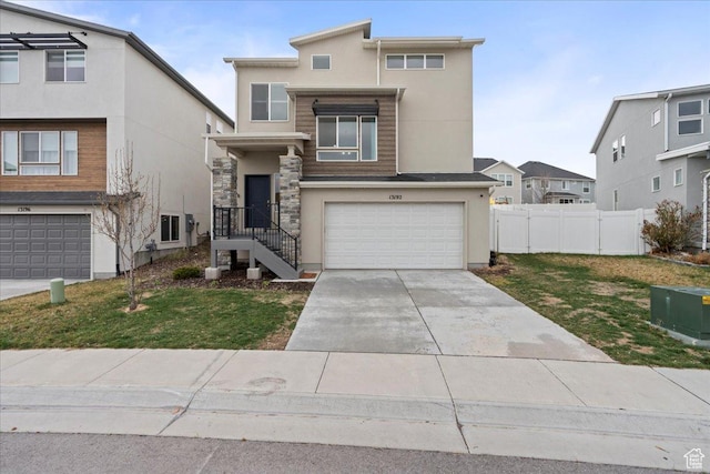 13192 S Lowick Ln, Herriman, UT 84096 - view of front of property featuring concrete driveway, stucco siding, fence, stone siding, and a garage