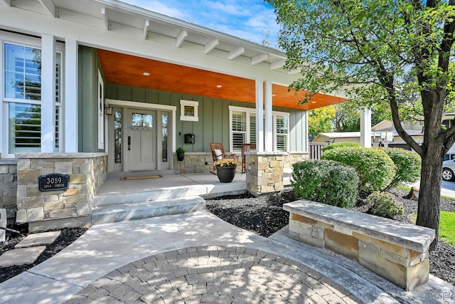 3059 S Lola Cir, Millcreek, UT 84109 - view of exterior entry with stone siding, board and batten siding, and a porch