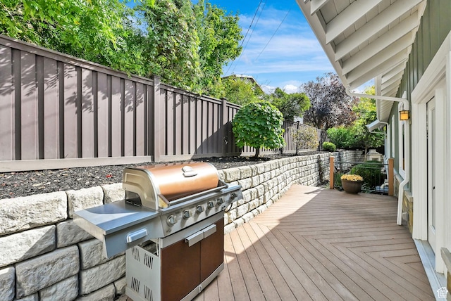 3059 S Lola Cir, Millcreek, UT 84109 - wooden deck featuring a fenced backyard, grilling area, and an outdoor kitchen
