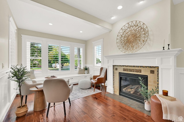 3059 S Lola Cir, Millcreek, UT 84109 - living area featuring a wainscoted wall, a tiled fireplace, wood finished floors, and a decorative wall