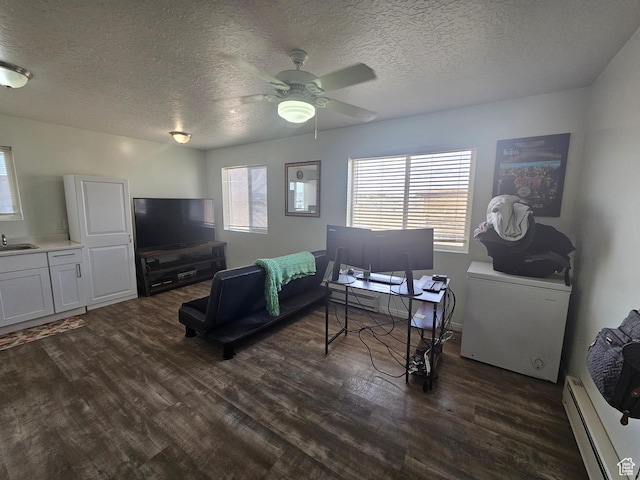 345 E 800 N, Duchesne, UT 84021 - living room featuring a textured ceiling, dark wood-style floors, a ceiling fan, and a baseboard radiator