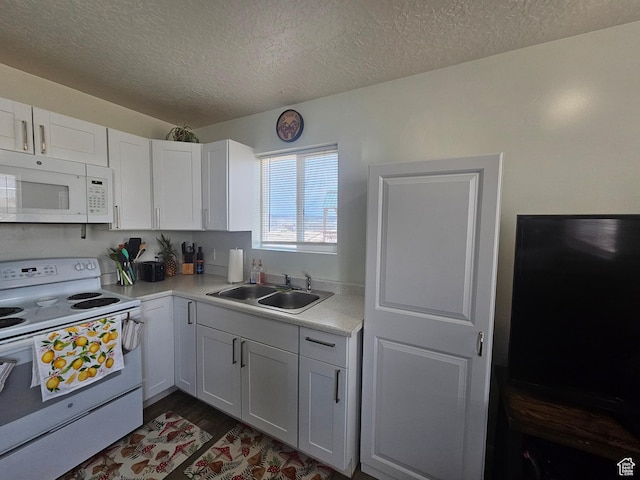345 E 800 N, Duchesne, UT 84021 - kitchen featuring light countertops, white appliances, a textured ceiling, a sink, and white cabinets