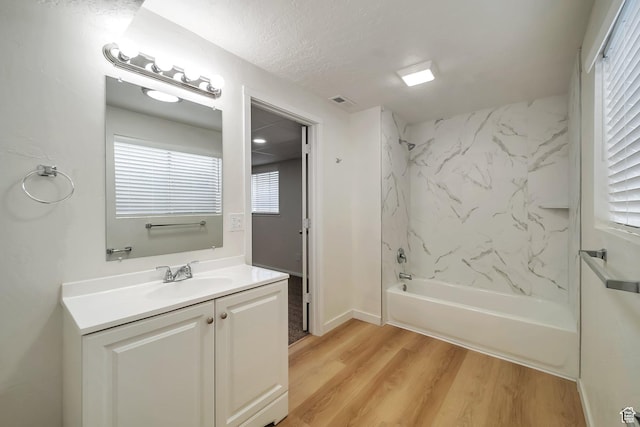 4195 W Kirkcaldy Cir S, South Jordan, UT 84009 - full bathroom with a textured ceiling, vanity, visible vents, wood finished floors, and washtub / shower combination