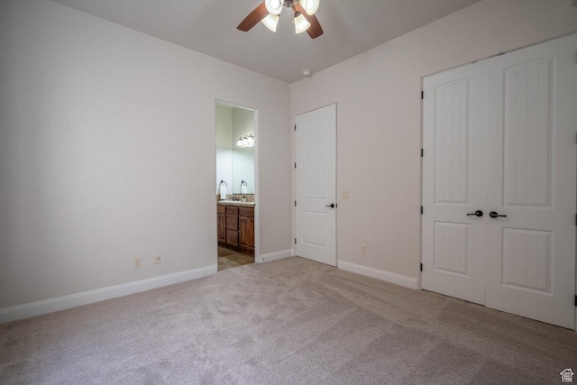 2104 S Corral Way, Washington, UT 84780 - unfurnished bedroom featuring a closet, ensuite bathroom, baseboards, and light colored carpet